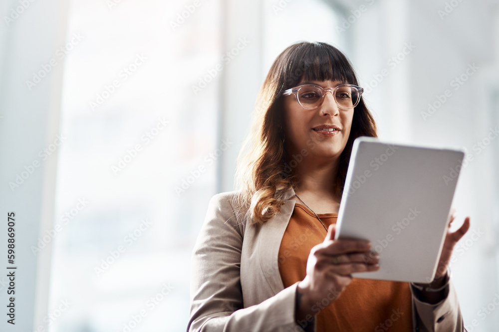 Shell always get the job done. an attractive young businesswoman using a digital tablet in her office. Shell always get the job done. an attractive young businesswoman using a digital tablet in her office.