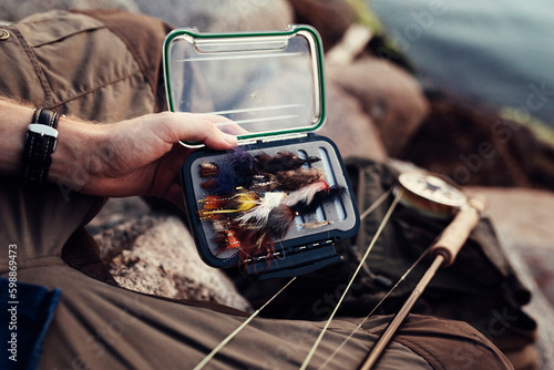 Close-up of man holding fishing bait