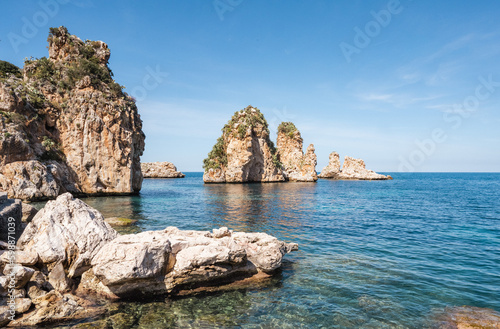 The bay of the former tuna catchers Tonnara di Scopello is located on the blue Tyrrhenian Mediterranean Sea in a picturesque setting between rugged rocks and green hills.