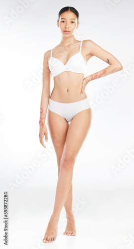 May your skin be glowing and your coffee strong. an attractive young woman posing in her underwear against a white background.