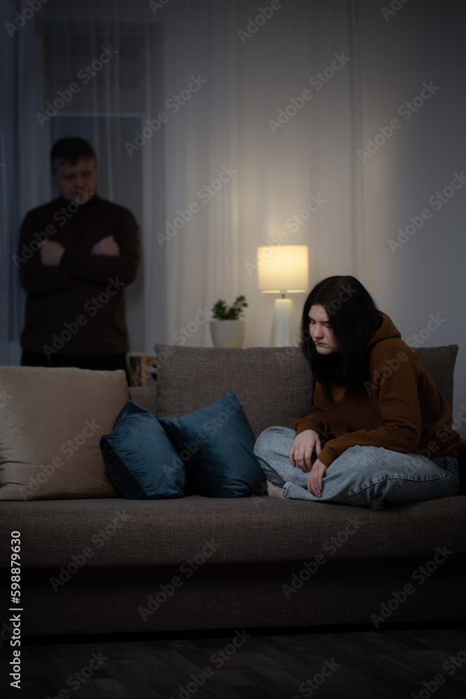 father and daughter teenager in living room in evening, concept of problems in family father and daughter teenager in living room in evening, concept of problems in family