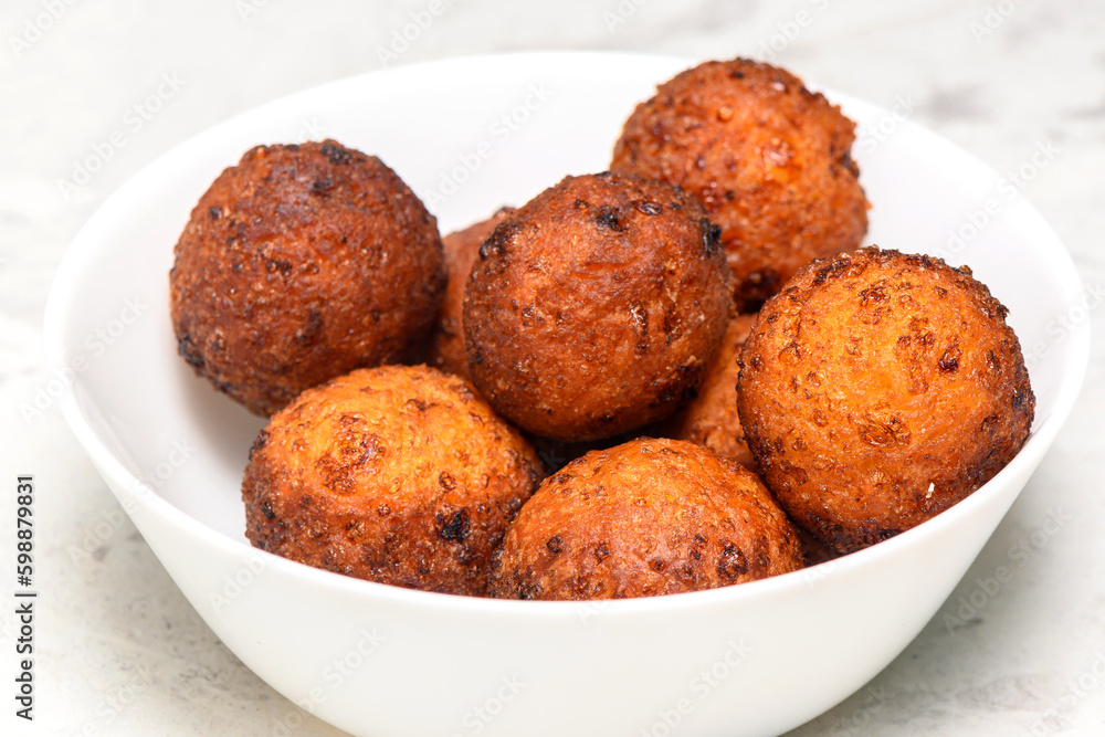 baked curd balls in a white plate on a marbled kitchen table baked curd balls in a white plate on a marbled kitchen table