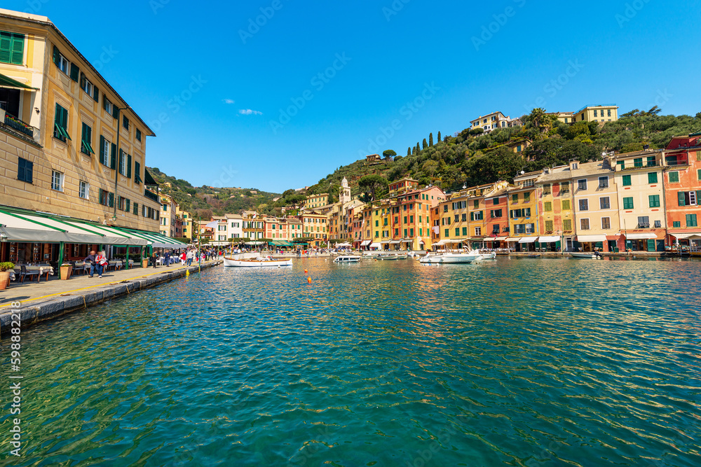 Port and cityscape of Portofino, luxury tourist resort in Genoa Province, Liguria, Italy, Europe. Colorful houses, Mediterranean sea (Ligurian sea).