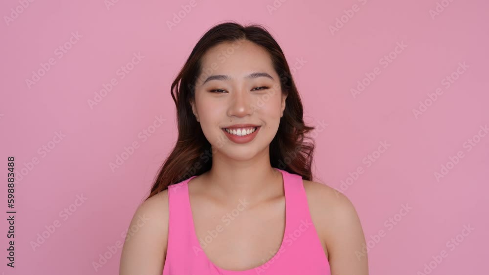Cheerful young woman smiles on pink studio. Generative AI Cheerful young woman smiles on pink studio. Generative AI