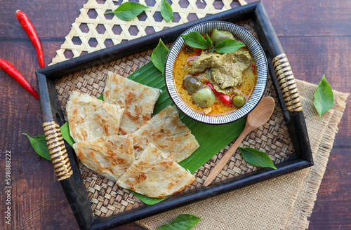 Thai green curry beef served with Roti at top view - Thai food called Roti Kang Keow Wan  photo