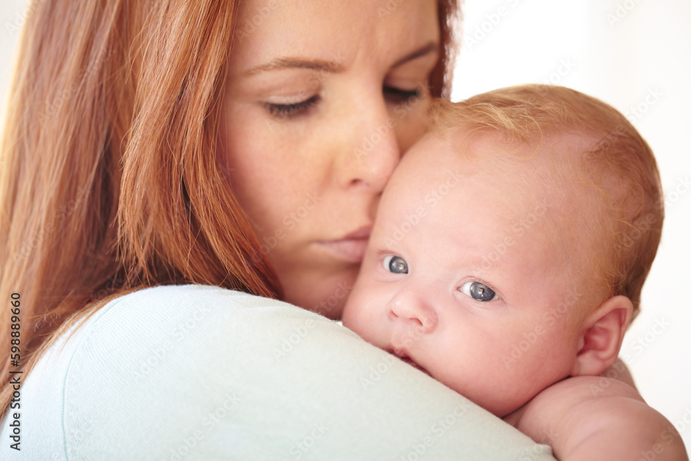 She loves him more than anything. Closeup of a cute baby boy being held by his mother. She loves him more than anything. Closeup of a cute baby boy being held by his mother.