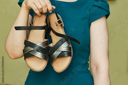 closeup woman holding beautiful woman summer sandal
