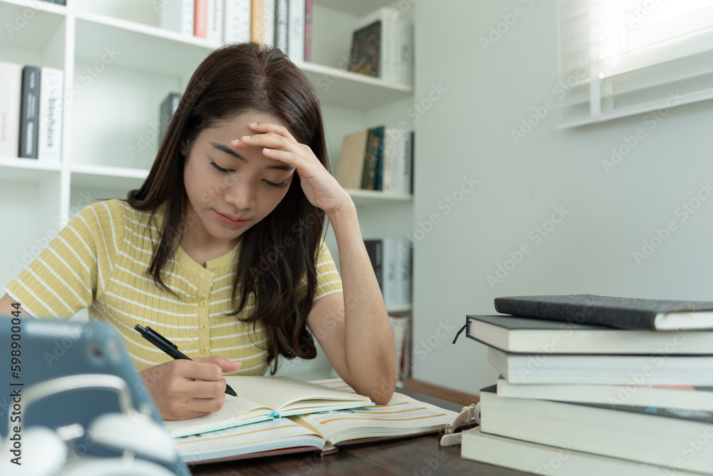 Asian student woman have anxiety because of exams, female prepare for test and learning lessons in the library. stress, despair, haste, misunderstanding reading, discouraged, expectation, knowledge. Asian student woman have anxiety because of exams, female prepare for test and learning lessons in the library. stress, despair, haste, misunderstanding reading, discouraged, expectation, knowledge.