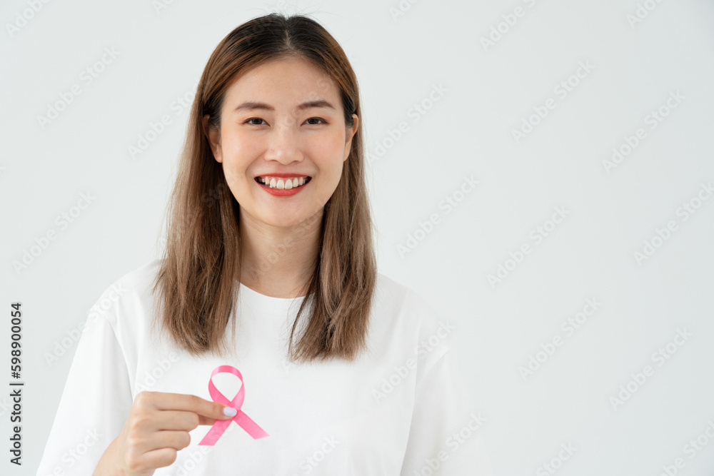Woman hold pink ribbon breast cancer awareness. Female health check consciousness. international Women Day and World Cancer Day. sign cancer, Symbolic, health care, support patients, timely diagnosis Woman hold pink ribbon breast cancer awareness. Female health check consciousness. international Women Day and World Cancer Day. sign cancer, Symbolic, health care, support patients, timely diagnosis