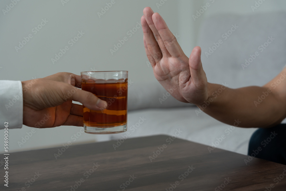Foto Stock man refuses say no and avoid to drink an alcohol whiskey