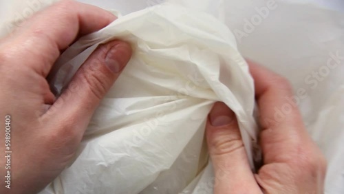 Biodegradable bag close-up. Texture of a biodegradable package. Hands feeling the packet