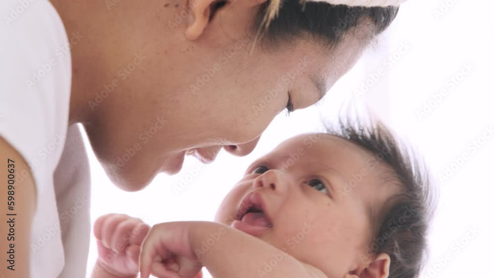 Asian mother talks and plays with her little baby with love and care. Asian mother talks and plays with her little baby with love and care.