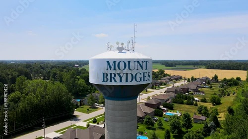 Drone circling around the Mount Brydges water tower on a sunny day. photo