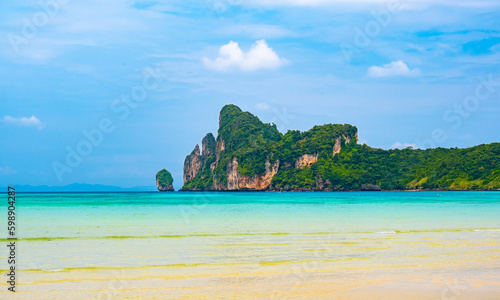 Fototapeta Naklejka Na Ścianę i Meble -  Landscape view of coastline with limestone rock and boats on ocean at Ko Phi Phi islands, Thailand. Concept of exotic tropical vacation and beautiful nature in paradise