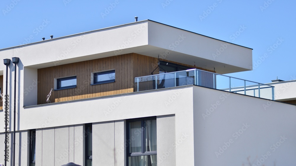 Terraced family homes in newly developed housing estate. The real estate market in the suburbs. New single family houses in a new development area. Residential homes with modern facade. 