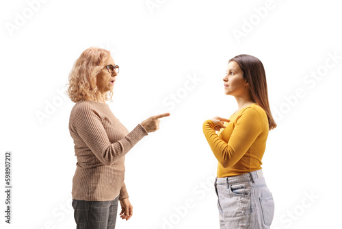 Profile shot of an angry mother having an argument with a female teenager