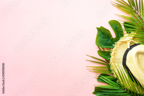 Summer composition flat lay. Palm leaves, sea shells, hat and sunglasses on pink background.