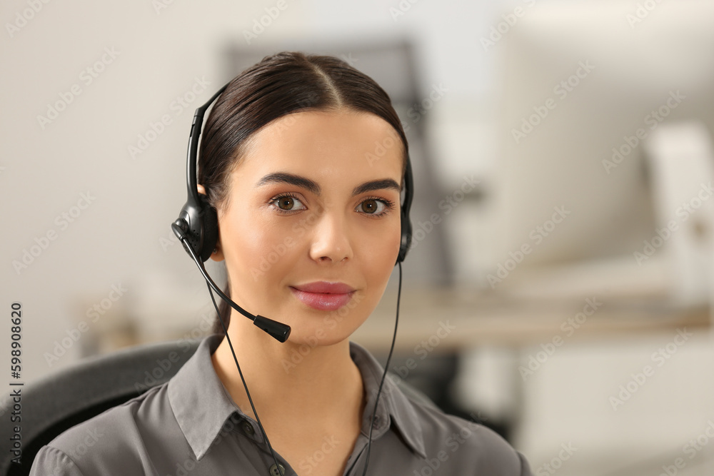 Hotline operator with headset working in office Hotline operator with headset working in office