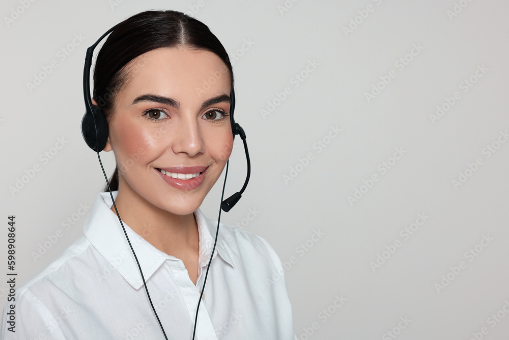 Hotline operator with modern headset on light grey background, space for text. Customer support Hotline operator with modern headset on light grey background, space for text. Customer support