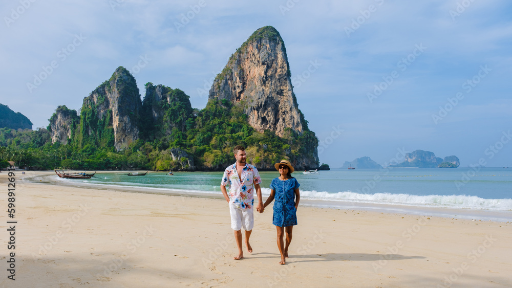 Fototapeta premium A couple of men and women at Railay Beach Krabi Thailand, the tropical beach of Railay Krabi