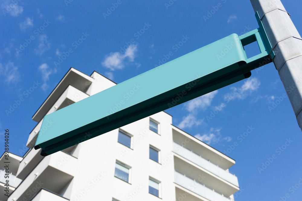 Street name pole. Signpost isolated on nlue sky. Empty copy space. Blank information place. Tourist guide arrow. Modern neighbourhood. Brand new block of flats. Sunny city balcony. Street name pole. Signpost isolated on nlue sky. Empty copy space. Blank information place. Tourist guide arrow. Modern neighbourhood. Brand new block of flats. Sunny city balcony.