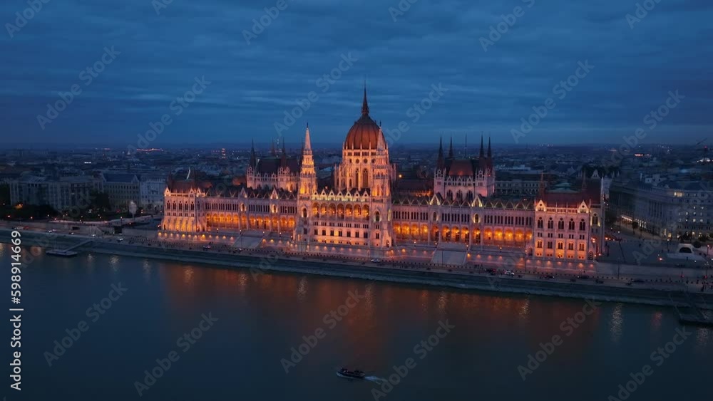 Aerial view of the illuminated Hungarian Parliament Building with the Danube river. Budapest, Hungary. Travel, tourism and European Political Landmark Destination Aerial view of the illuminated Hungarian Parliament Building with the Danube river. Budapest, Hungary. Travel, tourism and European Political Landmark Destination
