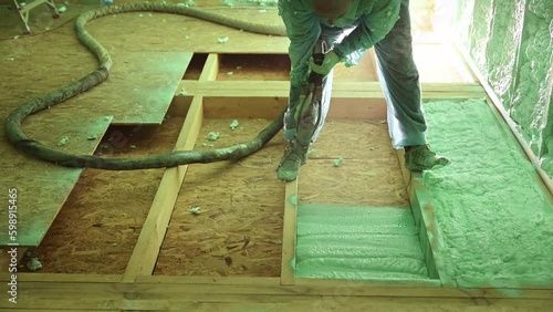 Male builder insulating wooden frame house. Man worker spraying polyurethane foam inside of future cottage, using plural component gun. Construction and insulation concept. Generative AI photo