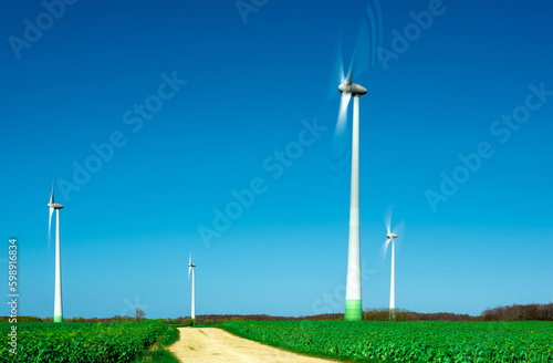 windmills spinning in the wind on a clear day © Robert