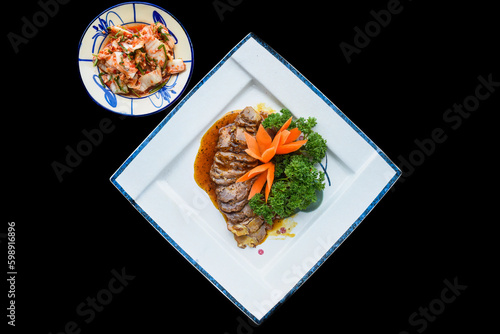 Roasted pork in soy sauce served with garlic and kimchi