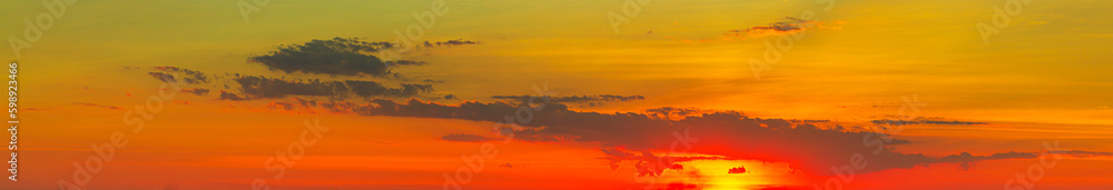 Fototapeta premium clouds and orange sky,Real amazing panoramic sunrise or sunset sky with gentle colorful clouds. Long panorama, crop it