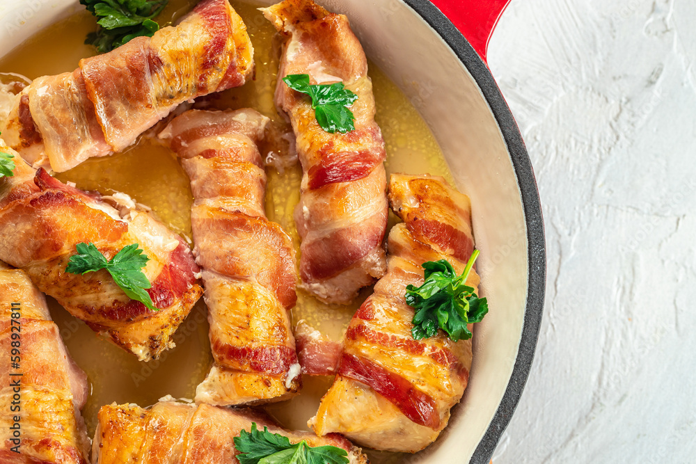 Bacon wrapped chicken drumsticks in pan. Healthy fats, clean eating for weight loss. place for text, top view