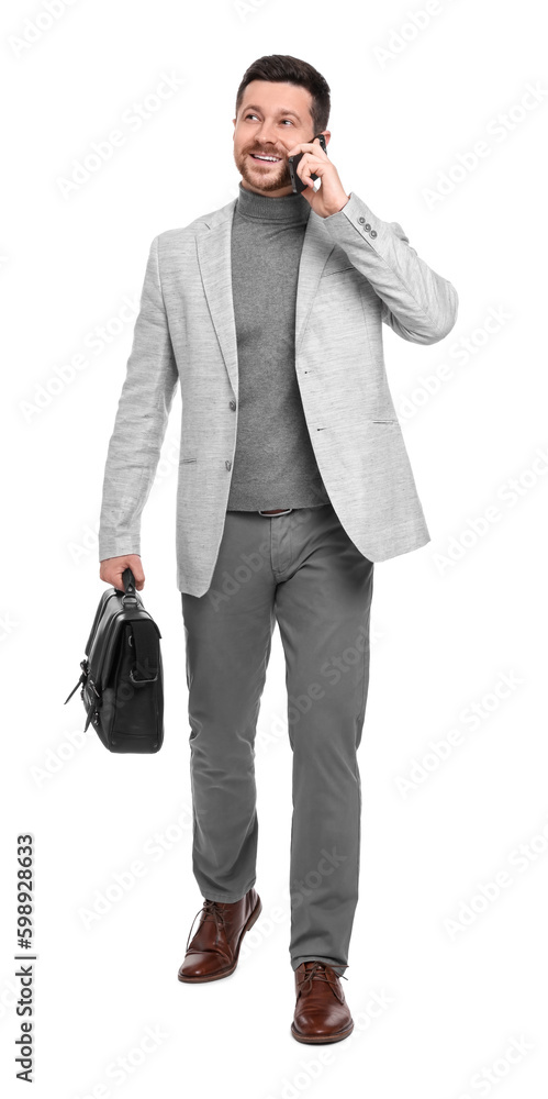 Fototapeta premium Handsome bearded businessman with briefcase talking on smartphone against white background