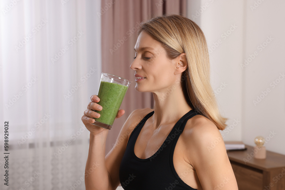 Young woman in sportswear with glass of fresh smoothie at home Young woman in sportswear with glass of fresh smoothie at home