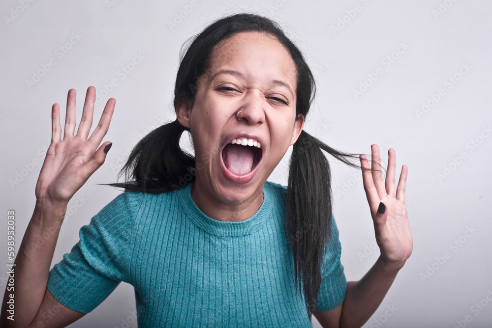 portrait of young woman screaming in madness. studio shot portrait of young woman screaming in madness. studio shot