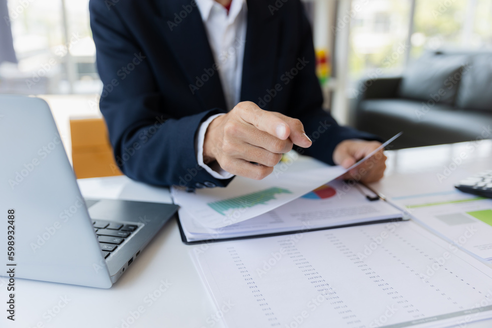 Male businessman working with calculator, business document and laptop computer notebook at room office. Male businessman working with calculator, business document and laptop computer notebook at room office.