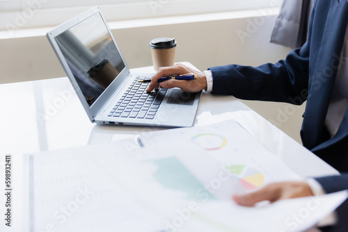 Male businessman working with calculator, business document and laptop computer notebook at room office.