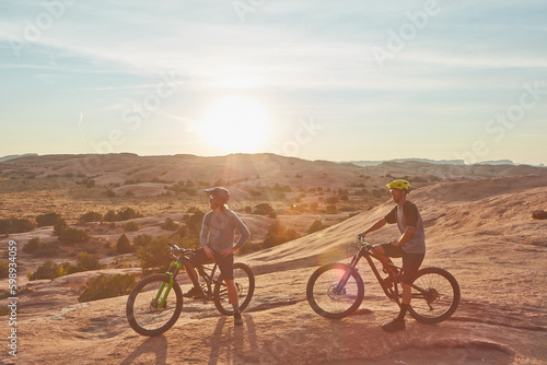 Theres nobody like a riding buddy. Full length shot of two young male athletes mountain biking in the wilderness.
