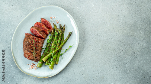 Obraz na płótnie sliced beef grill steak with green asparagus