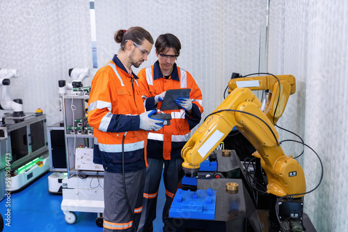 Engineer service robot welding in factory software programming operation test and commissioning
