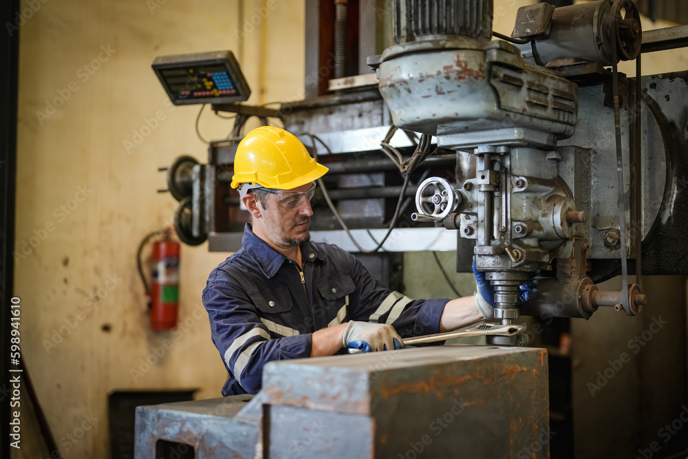 Lathe Operators Concentrated on Work. Worker in uniform and helmet works on lathe, factory. Industrial production, metalwork engineering, manufacturing. Lathe Operators Concentrated on Work. Worker in uniform and helmet works on lathe, factory. Industrial production, metalwork engineering, manufacturing.