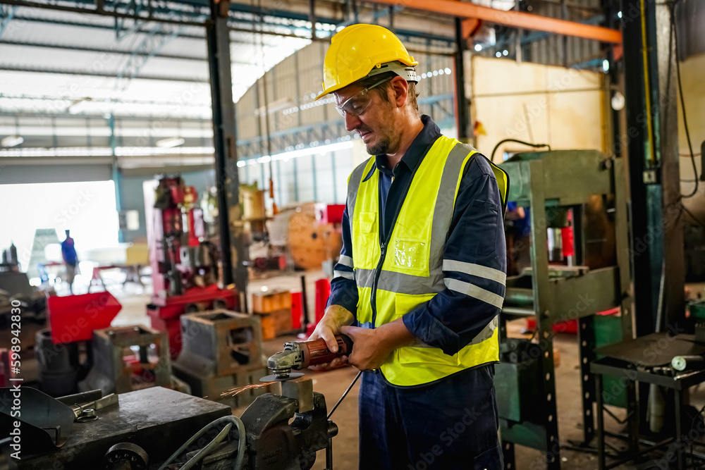 Male technician programs a robot arm with a digital tablet and assembly robot in a factory. Apprentice engineers programming robots in factory. Male technician programs a robot arm with a digital tablet and assembly robot in a factory. Apprentice engineers programming robots in factory.