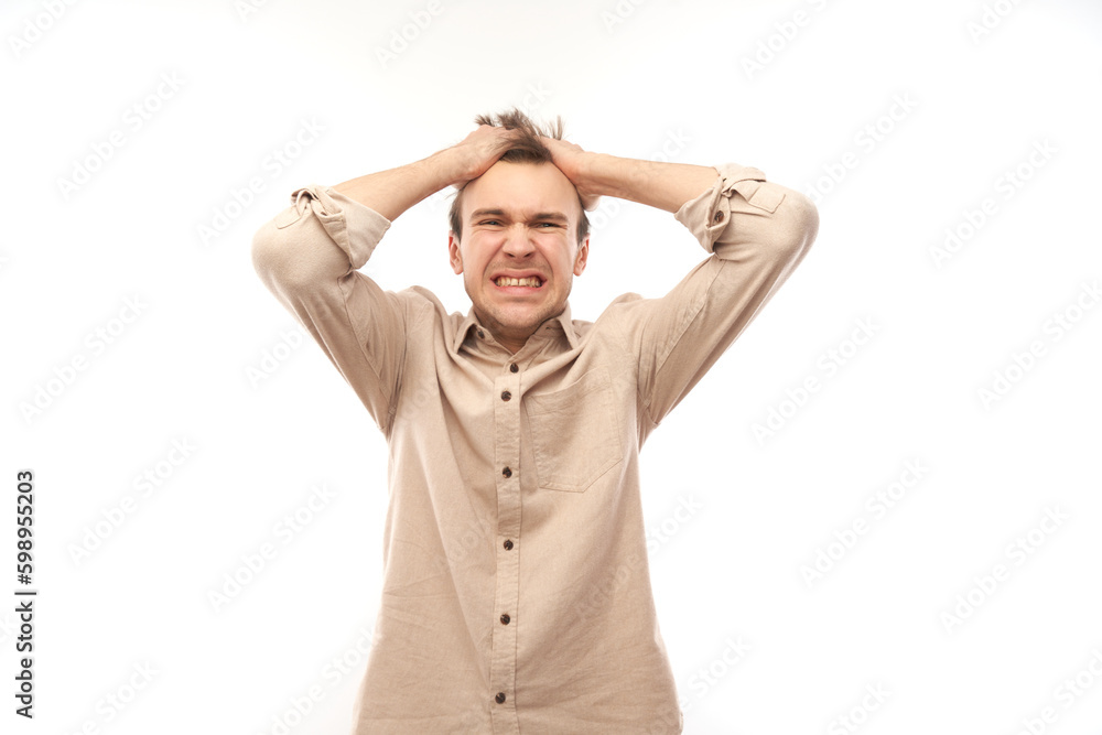 Portrait angry brunette young male screaming isolated on white studio background, showing negative emotions Portrait angry brunette young male screaming isolated on white studio background, showing negative emotions