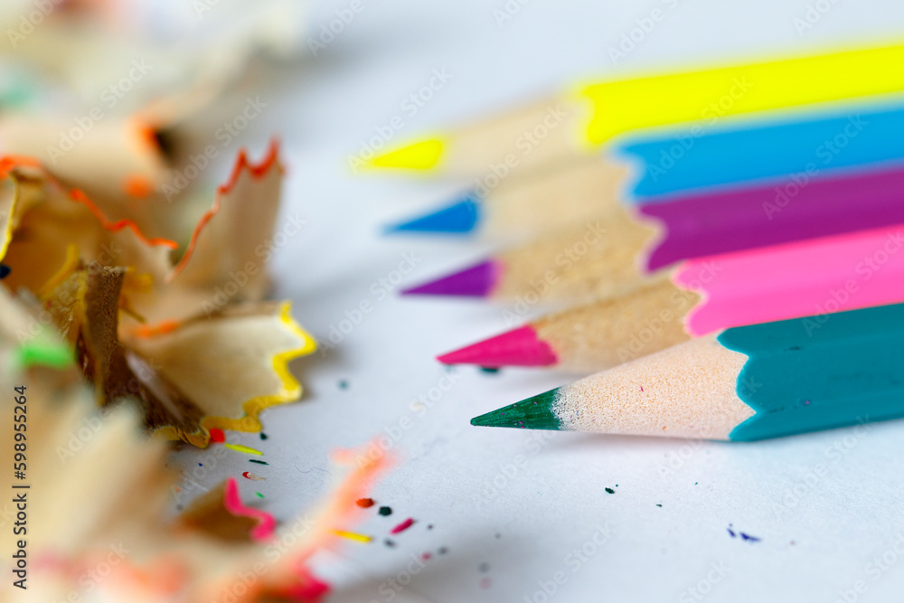 Close up pencil and color pencil stack with shavings. Artistic education concept white background. Close up pencil and color pencil stack with shavings. Artistic education concept white background.