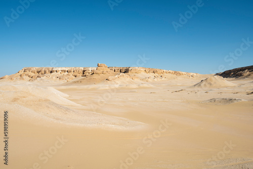 Barren desert landscape in hot climate with mountain rock formation