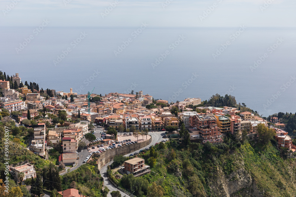 Panormaic view on Taormina town on top of a hill in Sicily on beautiful day