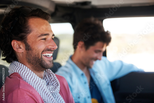 Good times with a great friend. Two friends happy and laughing together while on a drive. © Marine Gastineau/peopleimages.com
