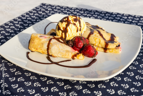 Palacsinta, traditional Hungarian sweet pancakes served with fruit and a scoop of ice cream, Delicious dessert photo