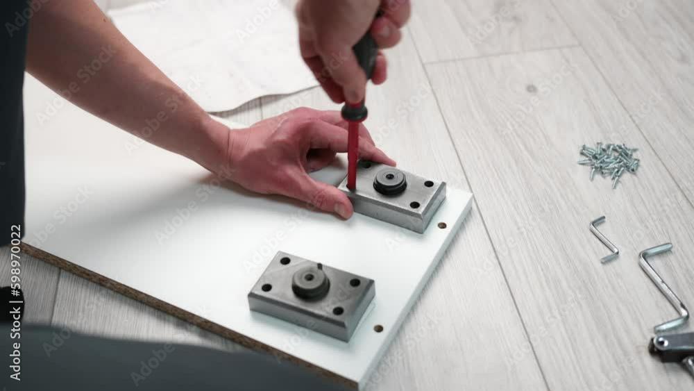 Furniture assembly. The worker installs the legs of the furniture, tightening the screws with a screwdriver,close-up . Generative AI Furniture assembly. The worker installs the legs of the furniture, tightening the screws with a screwdriver,close-up . Generative AI