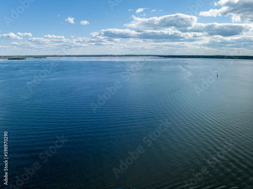 Niegocin lake in Gizycko, Poland, Mazury - drone aerial photo, nature lake landscape, cloudy sky, sailboats