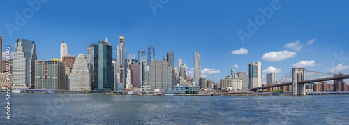 panorama of Manhattan and brooklyn bridge across the East River from Brooklyn